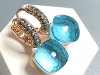 Boucles d’oreilles Nudo en cristal zircon, topaze bleue et 30 couleurs disponibles. Plaqué or rose, bijou féminin élégant et lumineux, idéal en cadeau.